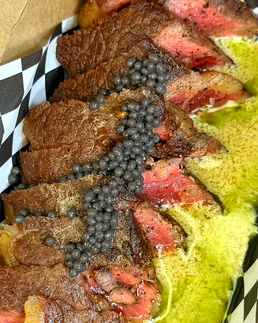 Seared Angus striploin with Dijon cream sauce and caviar on a plate